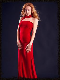 Wearing stylish red dress that hugs her body curves, her...